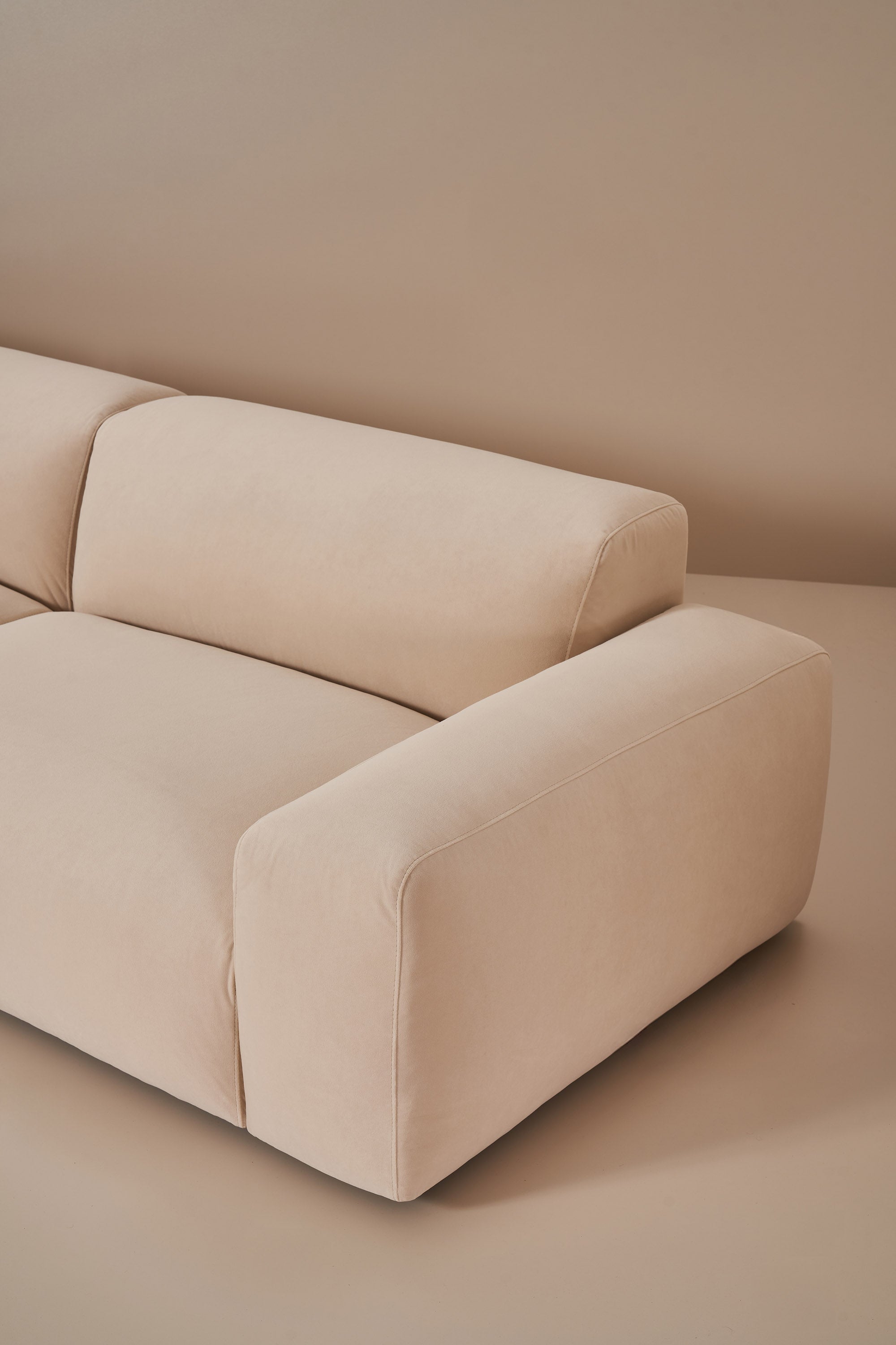 Beige sofa against a plain wall