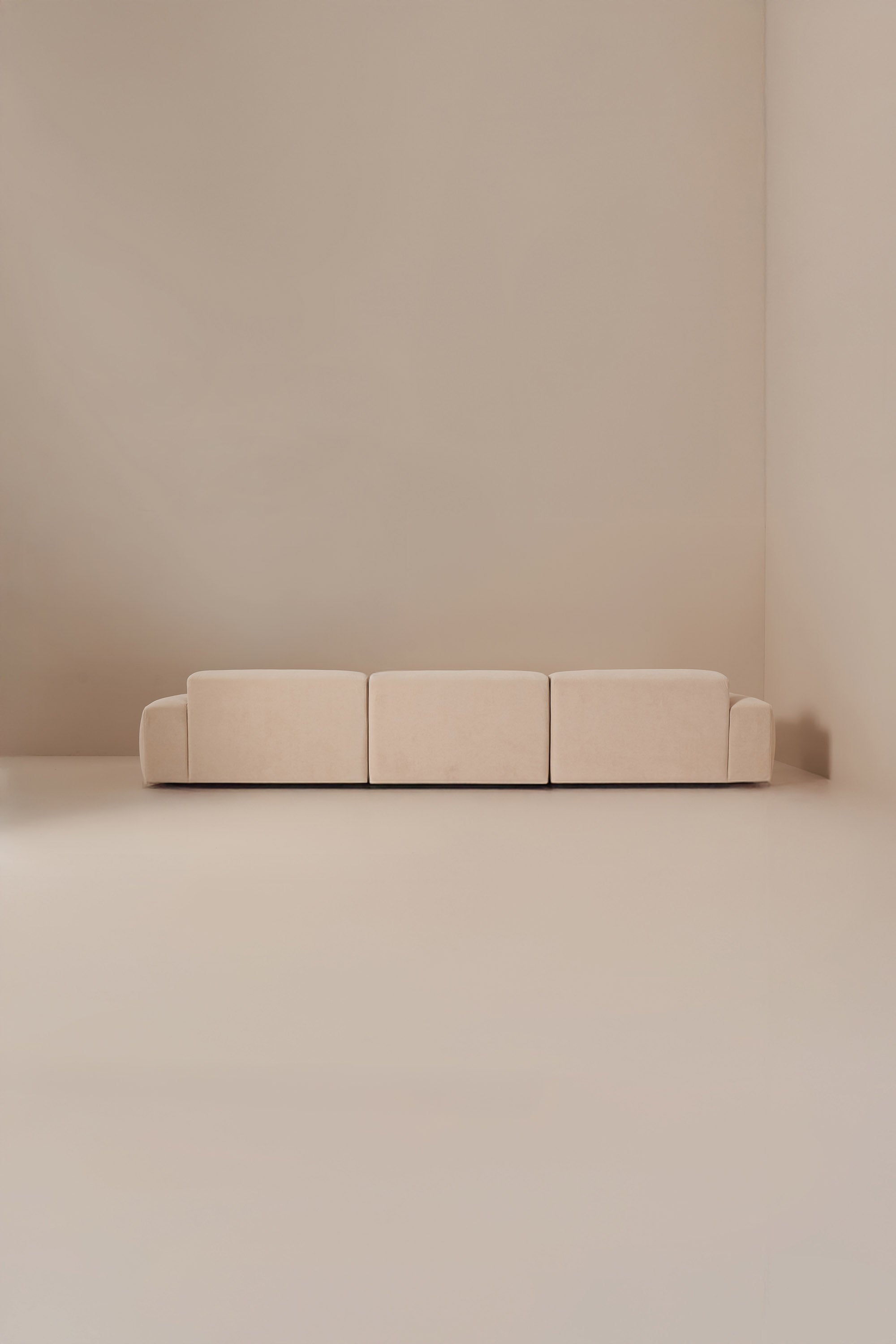 Beige sofa against a plain beige wall