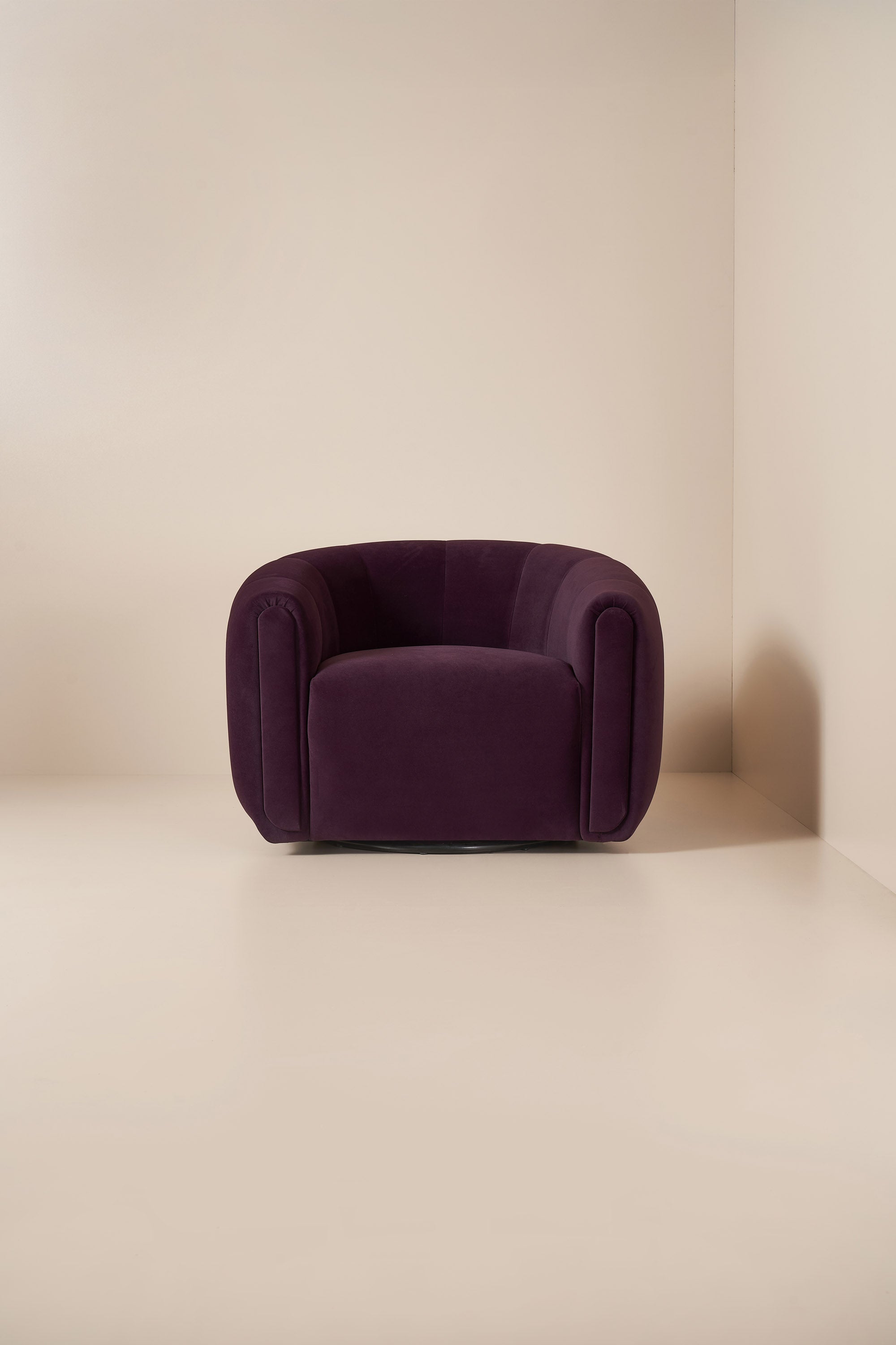 Purple armchair against a plain beige wall