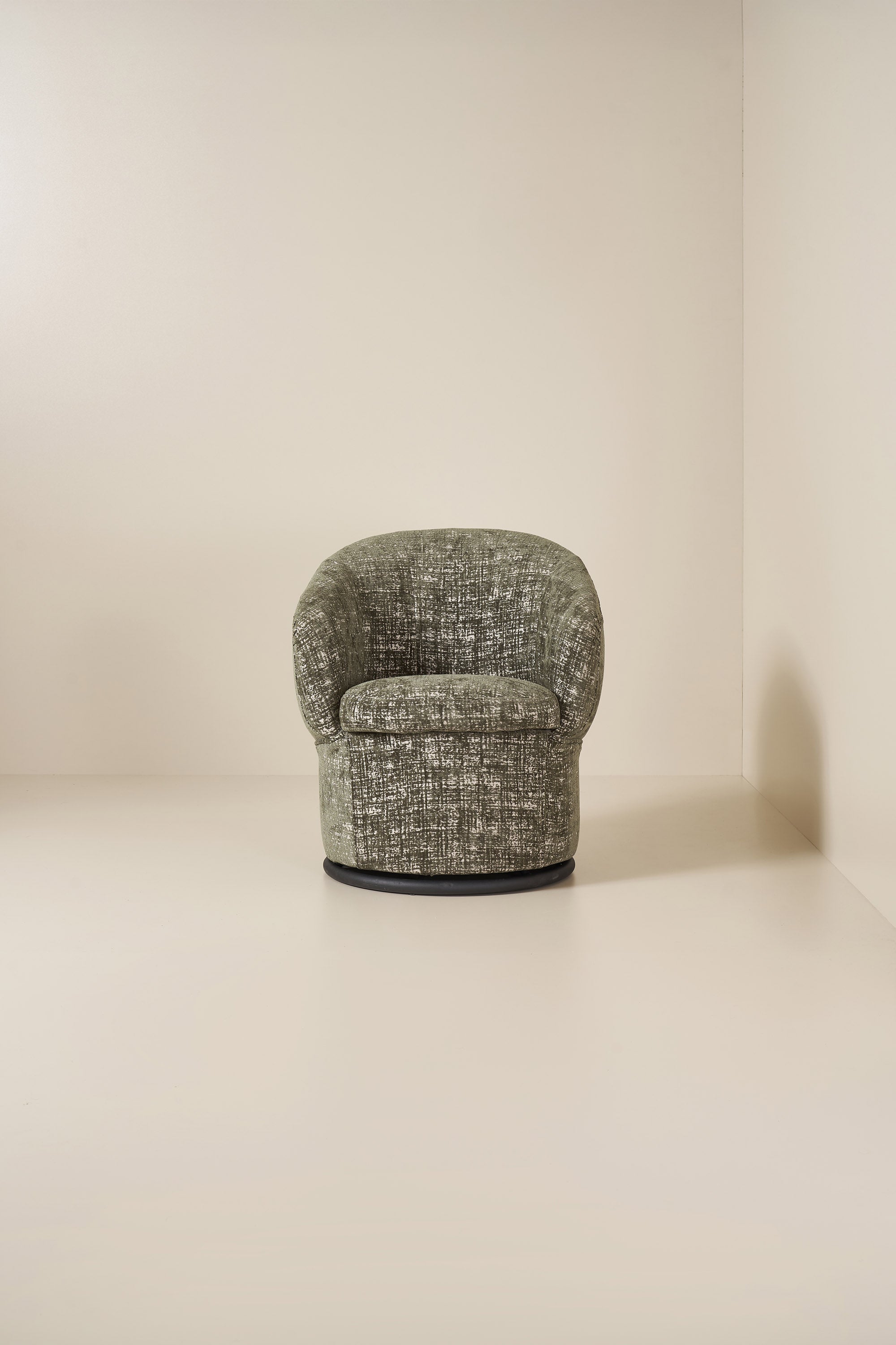 Textured green armchair on a neutral background