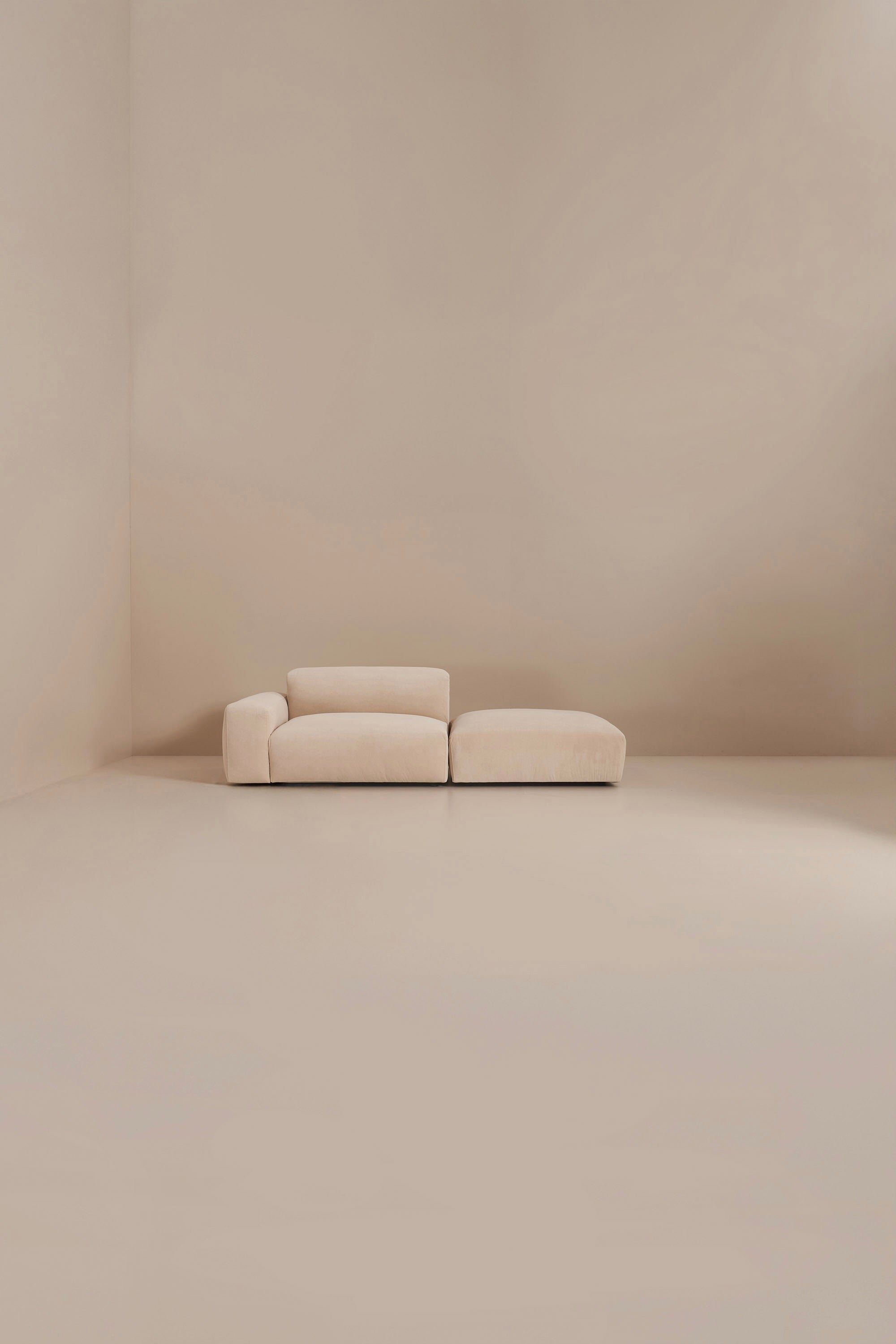 Beige sofa against a plain beige wall