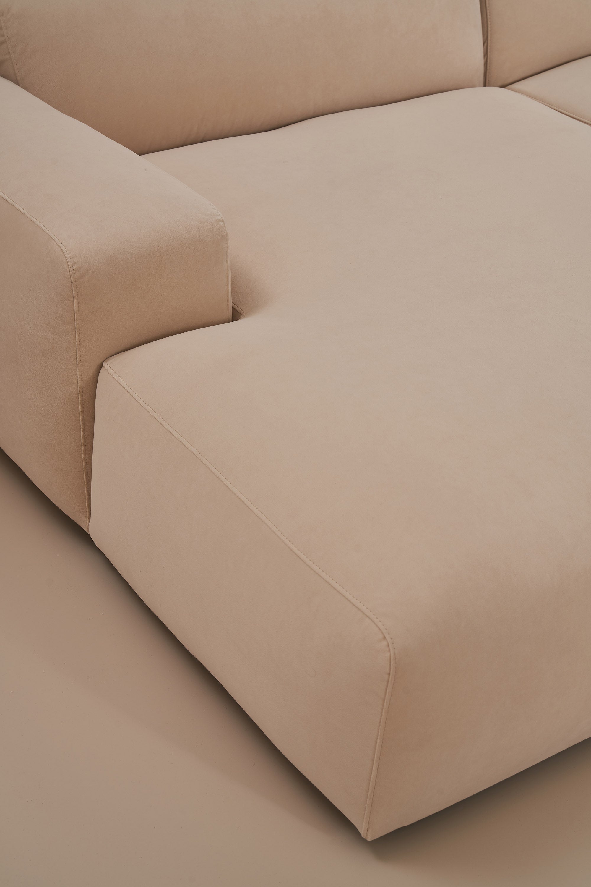 Beige sectional sofa on a plain background