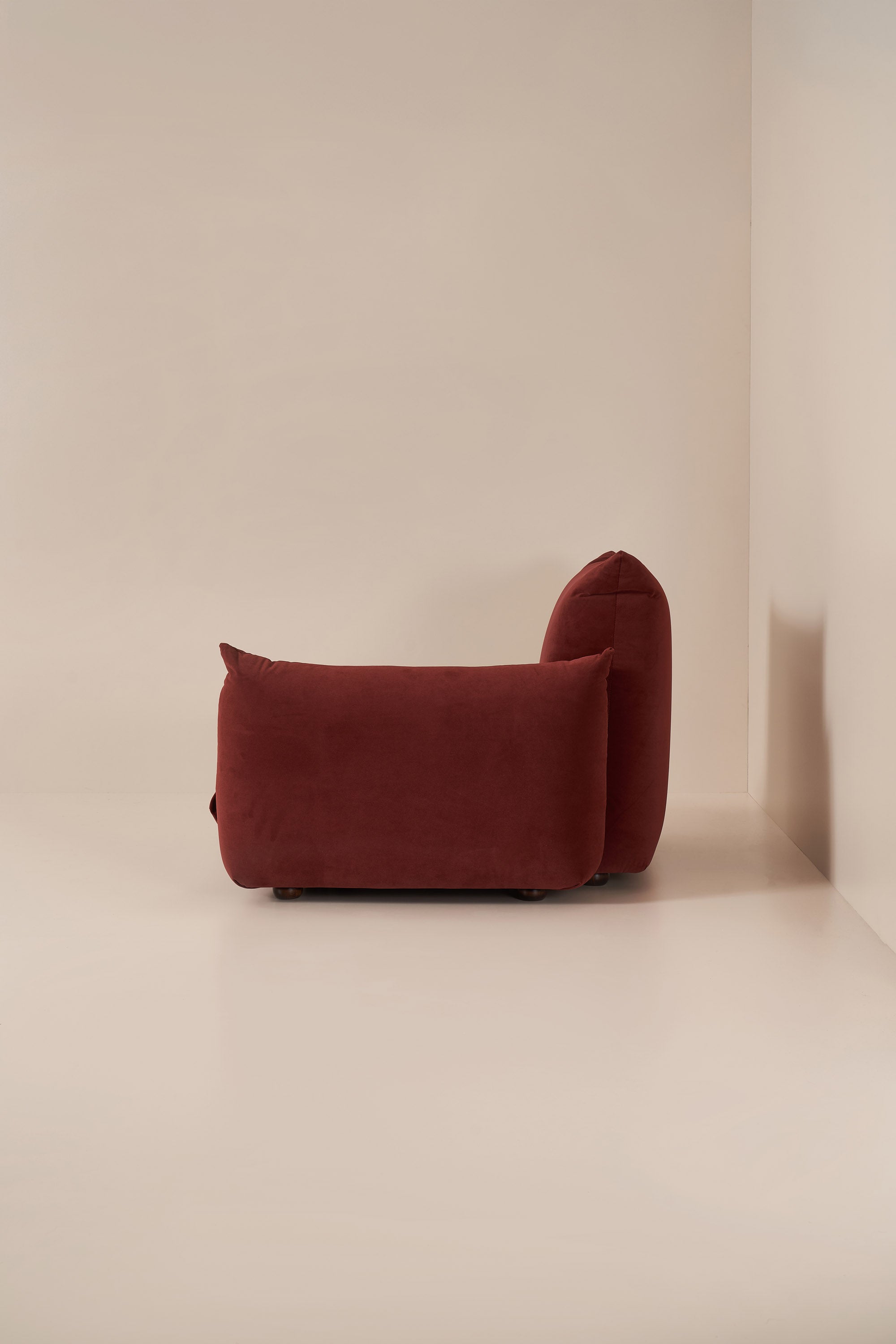 Red modular sofa against a beige wall