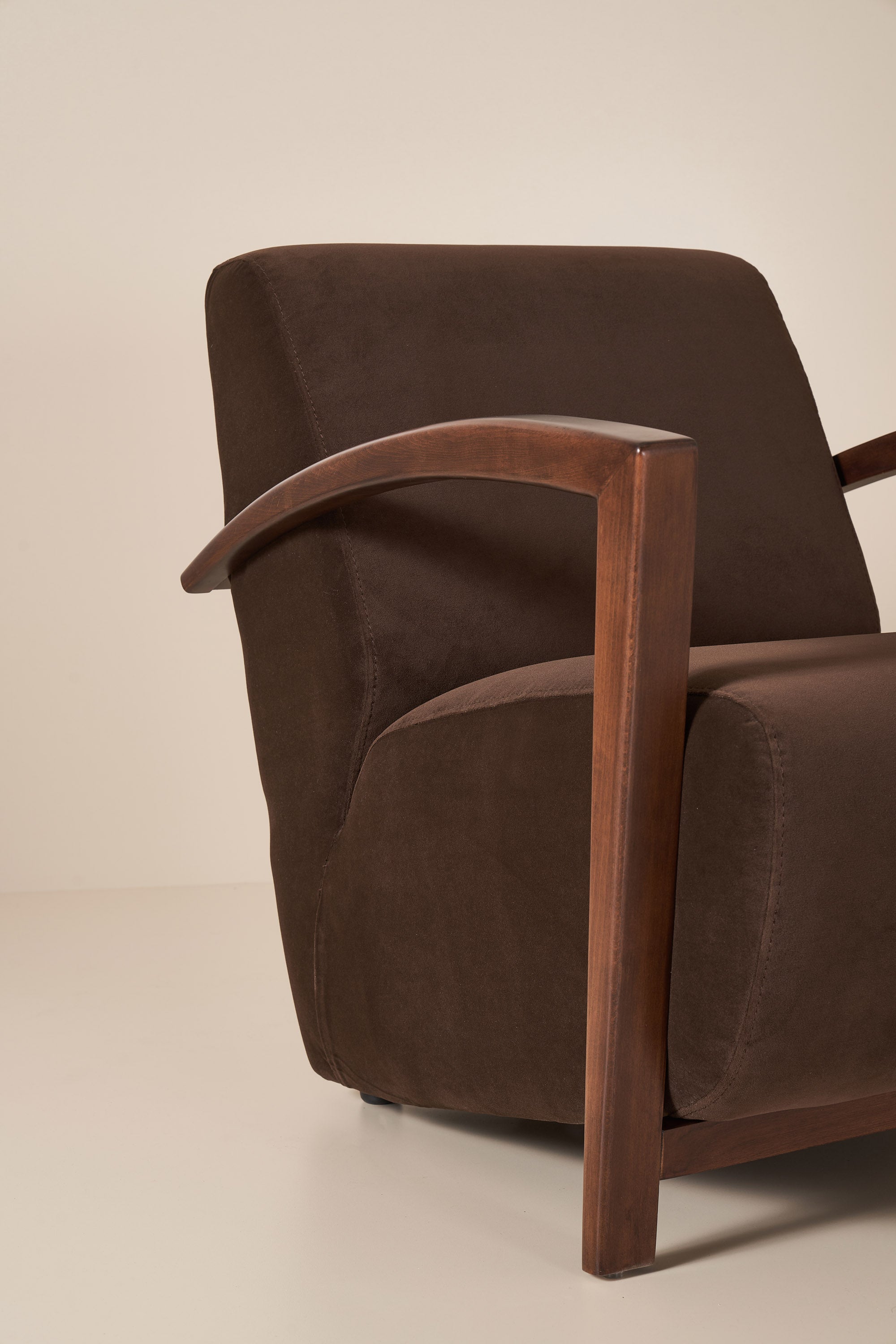 Brown armchair with wooden armrests