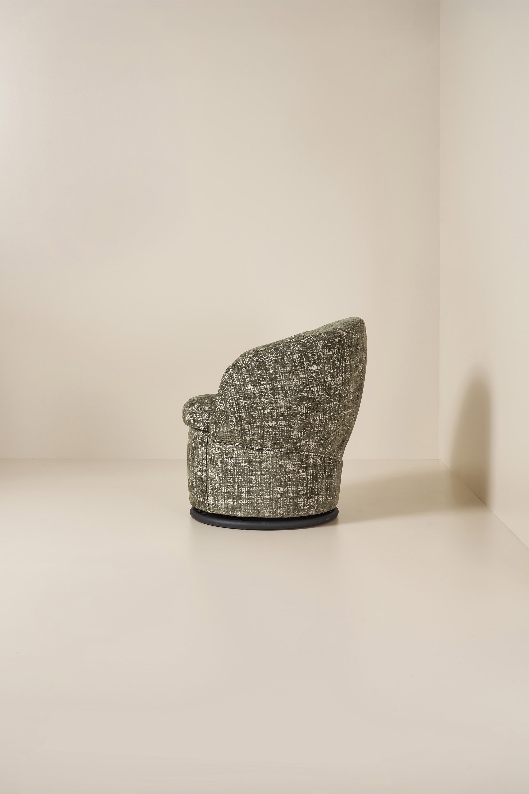 Textured green armchair on a neutral background