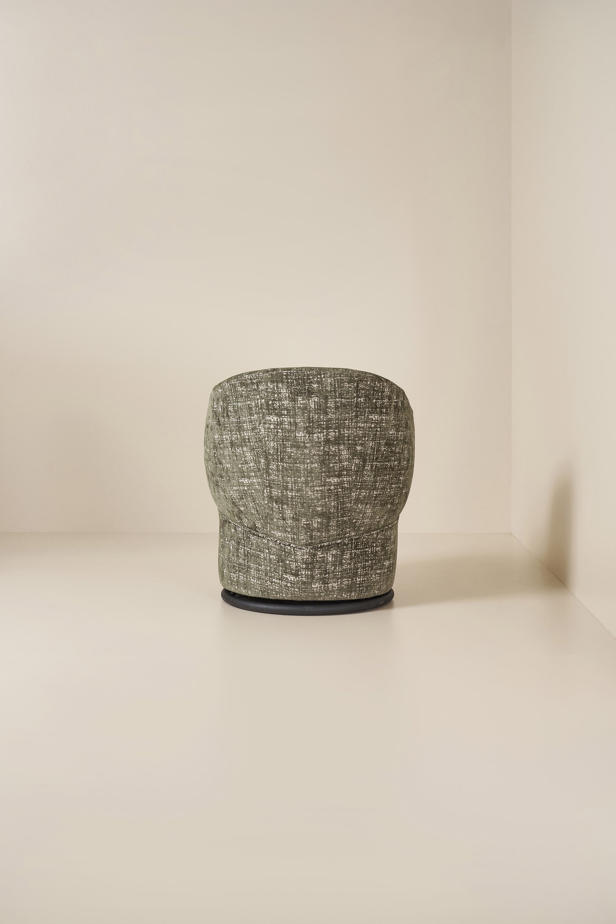 Textured green armchair on a neutral background