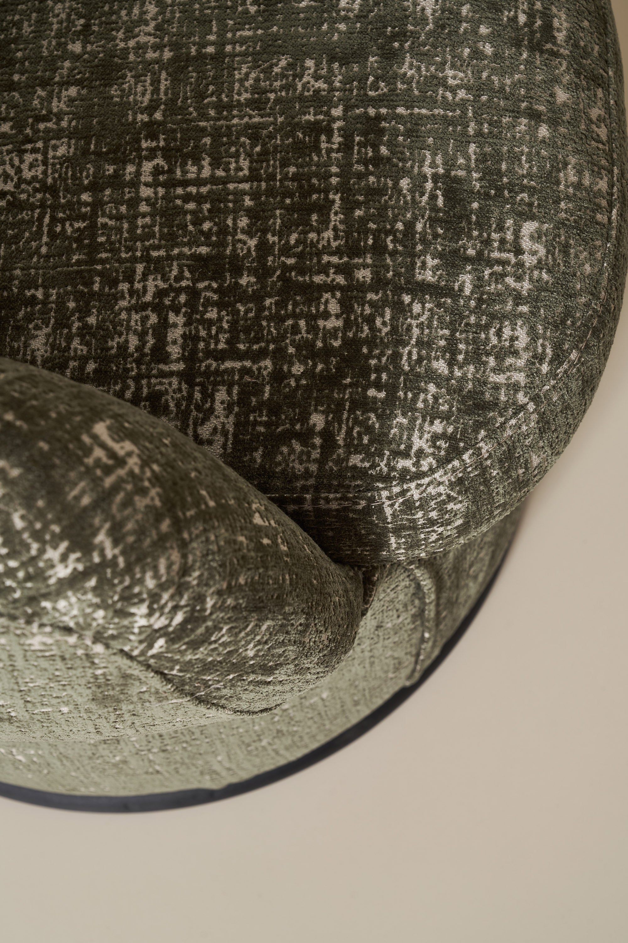 Close-up of a textured green fabric surface with a pattern