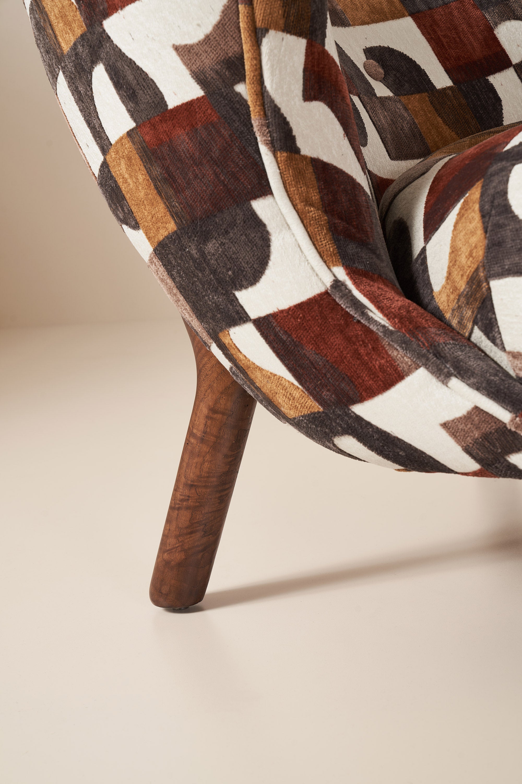 patterned armchair with wooden legs