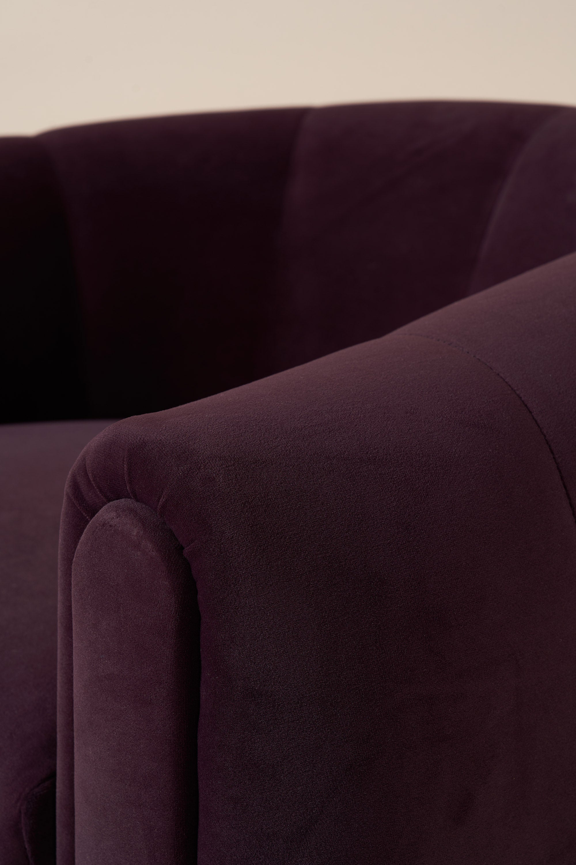Close-up of a dark purple velvet armchair